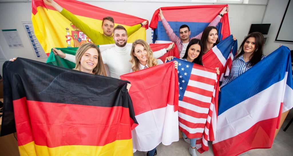 Students holding various flags of different countries in the classroom